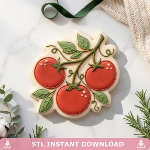 May include: A decorated cookie shaped like a tomato branch, featuring three red tomatoes, green leaves, and stems. The cookie has a light beige border and white dot details. The text "STL INSTANT DOWNLOAD" is at the bottom.