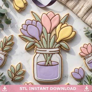 Peut inclure: Des biscuits décorés de fleurs aux couleurs pastel dans un pot Mason. Les biscuits sont décorés de fleurs violettes, roses et jaunes. D'autres biscuits présentent des feuilles et des fleurs simples. Le texte "STL INSTANT DOWNLOAD" est en bas.