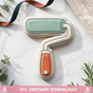 May include: A paint roller cookie with a light green roller, a cream-colored handle, and an orange grip. The cookie is outlined in gray and sits on a white surface. The text "STL INSTANT DOWNLOAD" is at the bottom.