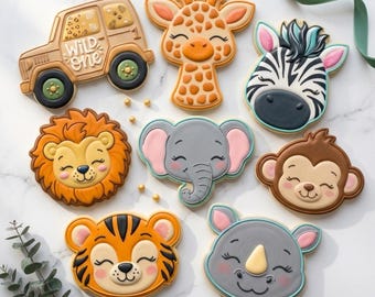May include: A collection of safari animal-themed cookies, including a giraffe, zebra, lion, elephant, monkey, tiger, and rhino. A brown jeep cookie with the text "Wild One" is also present. The cookies are decorated with various colors and details.