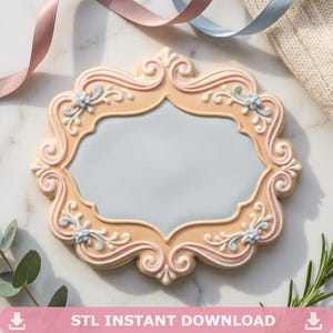 May include: An ornate frame in a soft peach colour with a light blue centre. The frame features intricate scrollwork and floral accents in shades of pink and white. The text "STL INSTANT DOWNLOAD" is at the bottom.