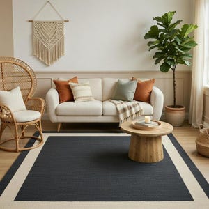 May include: A white ceramic mug with a black handle and the text "But First, Coffee" in a bold, black font. The mug is sitting on a wooden surface. The mug is approximately 4 inches tall.