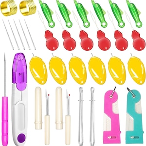 May include: A sewing tool kit containing two gold-tone metal thimbles, six silver needles, six green plastic needle threaders with red handles, six yellow plastic needle threaders, a pink awl, a purple seam ripper, two seam rippers with caps, two metal tweezers, and two plastic thread cutters in pink and teal.