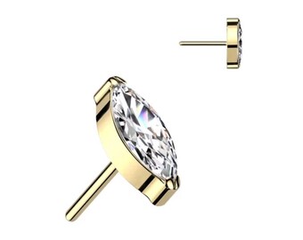 May include: A gold-colored stud earring with a marquise-cut, clear gemstone. The earring has a post for insertion and a bezel setting. The gemstone reflects light, creating a sparkling effect. The earring is shown from two angles.