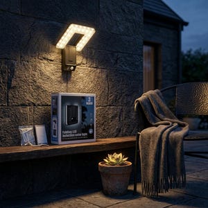 May include: A black folding LED induction solar light is mounted on a stone wall, illuminating the area. A box with the product name sits on a wooden shelf, along with a small succulent in a terracotta pot. A blanket rests on a chair.