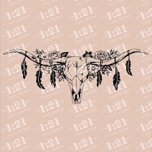 May include: A black line art graphic of a longhorn steer skull adorned with floral arrangements and hanging feathers. The design features detailed roses and leaves tucked between the horns, with multiple feathers suspended from the horn tips.