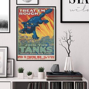 May include: A framed vintage poster with a black cat illustration. The cat is blue with yellow eyes, leaping against a fiery orange background. Text includes "TREAT 'EM ROUGH!" and "JOIN THE TANKS".
