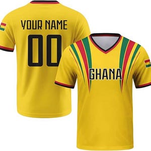 May include: A yellow short-sleeved V-neck jersey featuring the text GHANA on the front and YOUR NAME with the number 00 on the back. The design includes red, yellow, and green stripes, black trim, and the Ghana national flag on the sleeves.