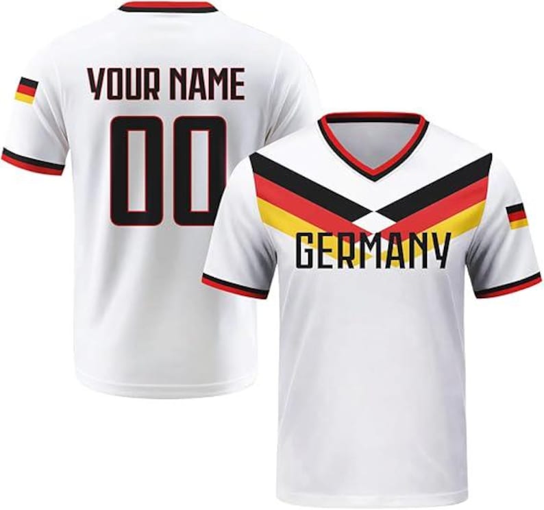 May include: A white V-neck jersey featuring a black, red, and yellow chevron pattern across the chest with the word GERMANY printed below. The back displays the text YOUR NAME and the number 00 in black with red outlines, plus a small German flag.