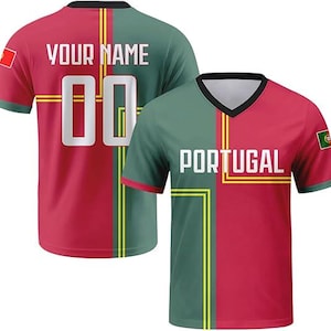 May include: A V-neck sports jersey featuring a split red and green design with yellow line accents. The front displays the text PORTUGAL in white, while the back shows the text YOUR NAME and the number 00. Both sleeves feature a small Portugal flag.