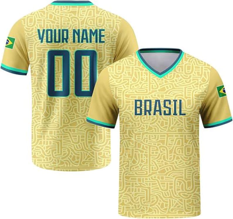 May include: A yellow V-neck jersey featuring a complex maze-like pattern in a lighter shade. The front displays the text BRASIL in dark blue, while the back shows YOUR NAME and the number 00. Both sleeves feature a small Brazil flag patch.