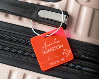 May include: Orange luggage tag with a white airplane and the text "Amelia WINSTON" and "123.456.7890".