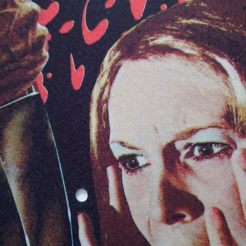 May include: Close-up of a woman's face with a worried expression. Her eyes are wide open and her mouth is slightly open. She is looking to the right of the image. The background is dark and blurry.