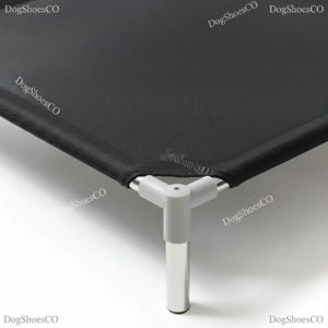May include: A black elevated pet bed featuring a durable mesh fabric surface stretched over a sturdy frame. The corner is secured with a light gray plastic joint connector that attaches to metallic legs, with the text DogShoesCO visible.