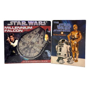 May include: Two Star Wars books. The left book is titled Star Wars Millennium Falcon YT-1300 A 3-D Owner's Guide, featuring Han Solo and the Millennium Falcon. The right book is The Star Wars Storybook with R2-D2 and C-3PO on the cover.