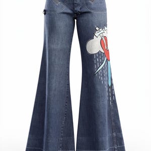 May include: Blue denim flared jeans with a graphic design on the right leg. The design features a red heart, white cloud, and blue rain. The jeans have front zipper pockets and a button closure.