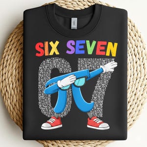 May include: Black sweatshirt featuring the words "SIX SEVEN" in rainbow hues. The number "67" is formed from pi symbols, and a blue pi symbol character is dabbing, wearing sunglasses and red trainers. A fun math-themed design.
