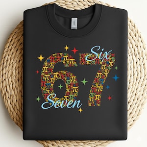 May include: Black sweatshirt featuring the numbers "67" and the words "Six" and "Seven" in a playful font. The numbers are composed of colourful pi symbols. Colourful star shapes are scattered around the numbers and words.