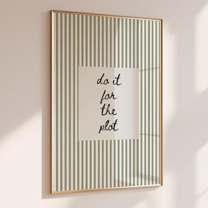 May include: A framed print with a gold border, featuring a striped background in shades of green and white. The print has a central rectangular area with the words "do it for the plot" in black script.