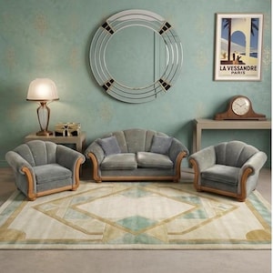May include: A stylish living room arrangement with a grey sofa and armchairs, set on a patterned rug. A large circular mirror and a vintage poster are on the teal-colored wall. The room also features a table lamp and a clock.