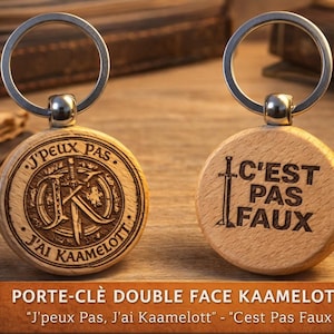 Puede incluir: Dos llaveros de madera con anillos plateados. Uno tiene el texto "J'peux Pas, J'ai Kaamelott" y un diseño con una espada y las letras "JK". El otro dice "C'est Pas Faux".