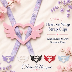 May include: A pink heart-shaped strap clip with wings, shown holding two lavender floral straps. Text reads: NEW! Heart with Wings Strap Clips, Keeps Dress & Shirt Straps in Place, Clean & Unique. Additional clips in purple, white, black, red, and blue.