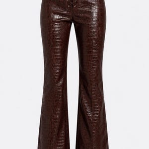 May include: Dark brown trousers featuring a glossy crocodile-embossed texture. These pants have a high-waisted design with a central lace-up closure using matching brown cord, vertical seam detailing down the front, and a flared leg silhouette.
