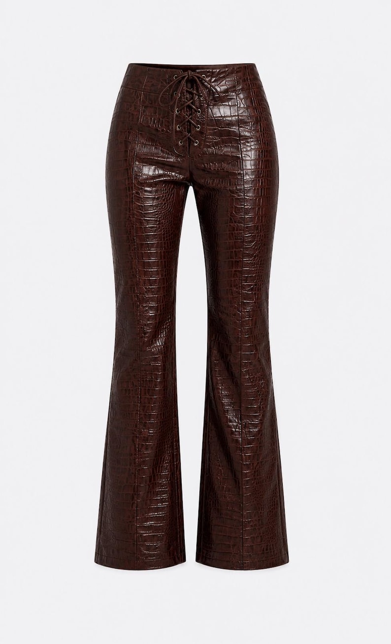 May include: Dark brown trousers featuring a glossy crocodile-embossed texture. These pants have a high-waisted design with a central lace-up closure using matching brown cord, vertical seam detailing down the front, and a flared leg silhouette.