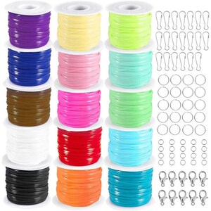 May include: A collection of fifteen spools of colorful cord in purple, yellow, lime, blue, pink, mint, brown, hot pink, light green, white, red, sky blue, black, orange, and teal, accompanied by metal jump rings and lobster claw clasps.