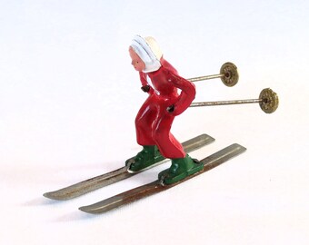 vintage lead figurine, Barclay, girl skier skiing, red ski suit, miniature, collectible figurines, Winter Sports, lead figurines