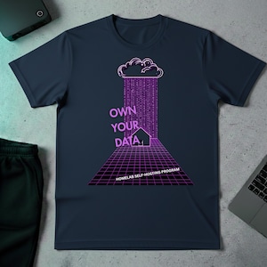 May include: Navy blue t-shirt with a graphic design featuring a cloud, rain of binary code, and the text "OWN YOUR DATA". Below the text is a house and a grid, with the text "HOMELAB SELF-HOSTING PROGRAM".