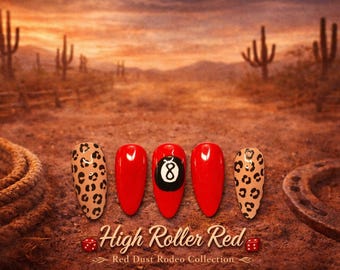 May include: Five almond-shaped press-on nails featuring a glossy finish. Two nails have a tan and black leopard print, two are solid red, and one centre nail is red with a black and white eight-ball graphic. Text reads High Roller Red.
