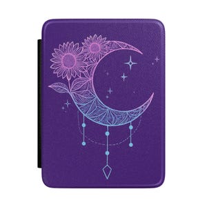 May include: Purple e-reader cover featuring a floral and celestial design. The cover has a black elastic band on the left side. The design includes two sunflowers, a crescent moon, stars, and dangling beads, all in shades of pink and blue.