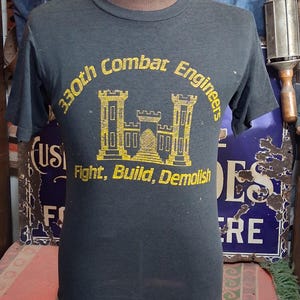 May include: A set of three ceramic mugs with a speckled, matte finish. The mugs are in shades of cream, light gray, and dark gray. Each mug has a simple, minimalist design, perfect for coffee or tea.