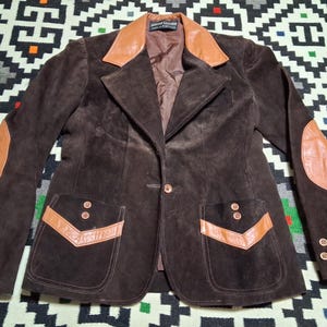 May include: A set of three ceramic mugs with a speckled, matte finish. The mugs are in shades of cream, light gray, and dark gray. Each mug has a simple, minimalist design and a rounded handle.