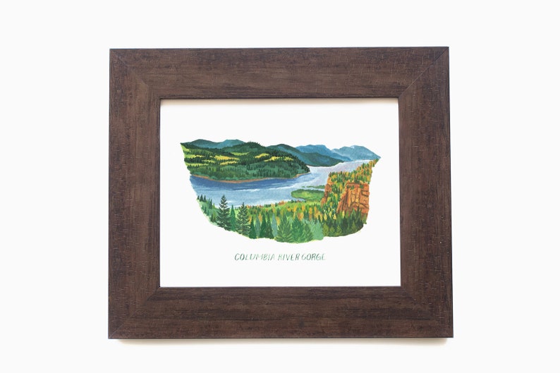 May include: Watercolour painting of the Columbia River Gorge in a dark brown wooden frame. The artwork depicts a river winding through a landscape of green trees, mountains, and cliffs. The text "COLUMBIA RIVER GORGE" is at the bottom.