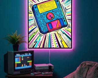 May include: A retro-themed room features a neon-lit artwork of a floppy disk, with a vibrant color scheme. A vintage TV displays a video game, complemented by a console and controllers. A neon clock and beanbag chair complete the nostalgic setup.