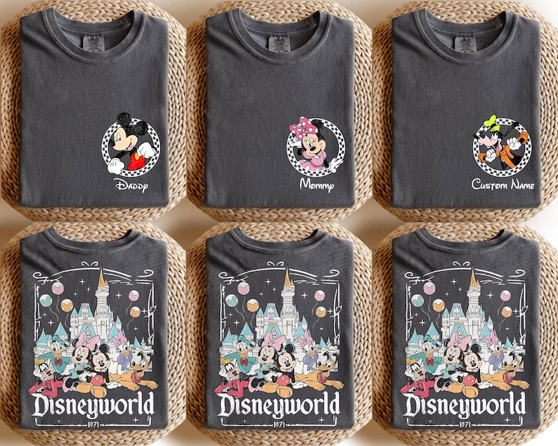 May include: Six charcoal gray t-shirts with Disney character designs. Three shirts feature Mickey and Minnie Mouse with text reading "Daddy", "Mommy", and "Custom Name". The other three shirts display a Disney World graphic with the text "Disneyworld 1971".