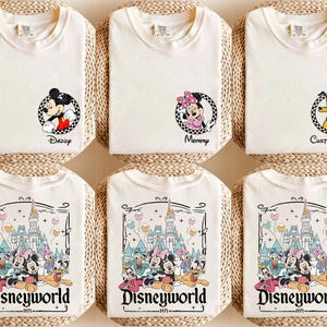 May include: Off-white t-shirts with Disney character graphics. Designs include Mickey Mouse with "Daddy", Minnie Mouse with "Mommy", and Pluto with "Custom Name". Other shirts feature a "Disneyworld" graphic with various characters.