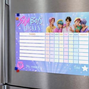 Op de afbeelding: Een magnetische takenlijst met de tekst "Skit Boys Chores" en een kleurrijke illustratie van vijf mensen. De lijst heeft vakken voor taken, dagen van de week en punten, met een beloningsgedeelte en een totale ster.