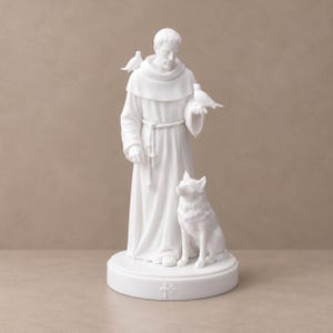 May include: A matte white figurine of a robed figure standing on a circular base. The figure wears a hooded garment with a rope belt, holding a small bird in one hand, with another bird on the shoulder and a dog sitting at the feet.