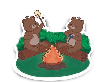 May include: A sticker featuring two brown cartoon bears sitting on logs around a campfire. One bear holds a marshmallow on a stick, while the other holds a flashlight. Green foliage and a green base complete the camping scene.