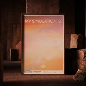 May include: A framed art print titled "MY SIMULATION: 2" with a gradient of orange, pink, and yellow hues. The artwork is displayed in a dark brown wooden frame, set against a textured, brown background.