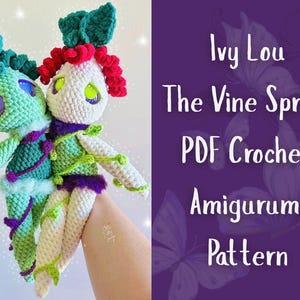 May include: Two handmade crochet dolls, one teal and one white, with green and red accents. The dolls have large eyes and are adorned with vine-like details. Text on a purple background reads "Ivy Lou The Vine Sprite PDF Crochet Amigurumi Pattern."