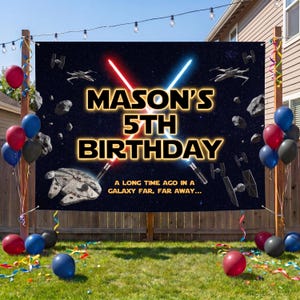 May include: A rectangular birthday banner featuring a dark space background with stars, asteroids, and spaceships. The text reads MASON'S 5TH BIRTHDAY and A LONG TIME AGO IN A GALAXY FAR, FAR AWAY... with crossed red and blue light sabers in the center.