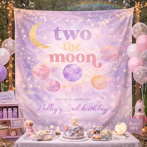 May include: A birthday party scene with a celestial theme. A backdrop with planets and the text "two the moon" is set up. Balloons, a cake, and other decorations are on a table. The text "Hadley's 2nd birthday" is also visible.