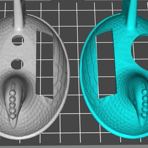 May include: A 3D-rendered image of two identical objects, one in gray and the other in teal. Each object has an oval shape with a textured surface, holes, and a protruding, rounded end. The objects appear to be a design or model.