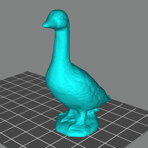 May include: A turquoise goose figurine with a textured surface. The goose has a long neck, a detailed body, and is standing on a base. The figurine is set against a gray background with a grid pattern.