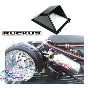 May include: Black motorcycle fairing with the word "RUCKUS" in a black and white rectangular box. The image also shows a motorcycle wheel, exhaust, and the text "Boosted Wbkz EST. 2023".