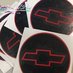 May include: A collection of circular stickers. Each sticker has a black background with a red bow tie logo. The stickers have a white border. The text "Boosted Wrkz" and "Est. 2026" is in the upper left corner.